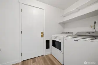Utility room with door to attached garage.