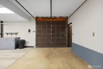 Garage door next to large basement shop