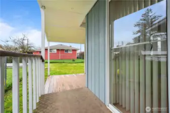 Slider door leads to covered back deck