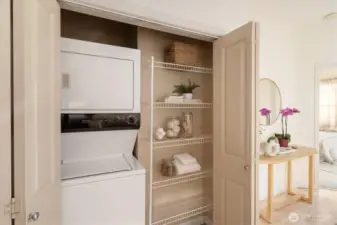 The in-unit laundry is tucked just off the kitchen and has shelving for your laundry items.