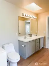 Primary Ensuite 5-piece Bathroom with skylight and double sinks & adjacent walk-in closet