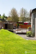 Another view of the large, fenced back yard with mature hydrangeas and other beautiful plants