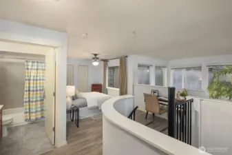 Upper level flowing seamlessly between bedroom, office space, and full bathroom.