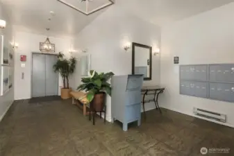 Lobby area featuring elevator and mail.