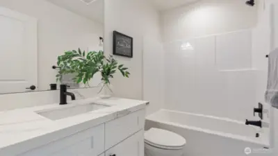 Photos for reference.  Same floorplan, similar features. Main Bath has quartz counters and tile flooring.