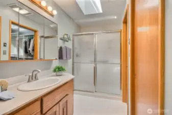 Primary Bathroom with large shower, skylight provides natural light and ventilation