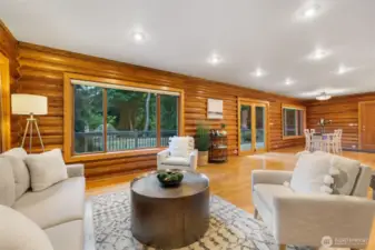 Living space is situated just off the kitchen and dining room with surrounding windows and lots of natural light.