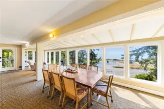 Large dining table looks out at the view. All of the furniture can be left in the house if you want an instant beachfront cabin.