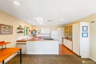 Simple kitchen that also has a view, and sits right beside the dining table. Gas burners and a comfortable, functional kitchen.