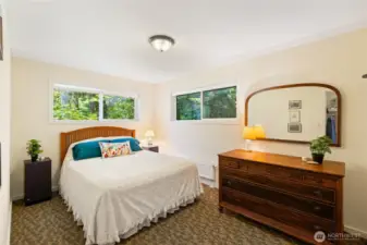 Bedroom #2 upstairs on the north side of the house. beautiful greenery outside the windows. Very private setting.