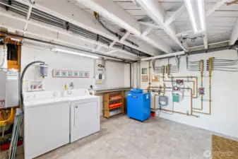 Utility room with washer/dryer, on-demand water heater, boiler and radiant heat system.