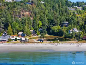 A look at Alexander Beach, Lake Chiquita, and the house peaking out of the trees. This is a private lake and beach.