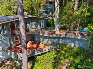 The house with 2 generous decks, and up the hell see the storage shed and bunkhouse.