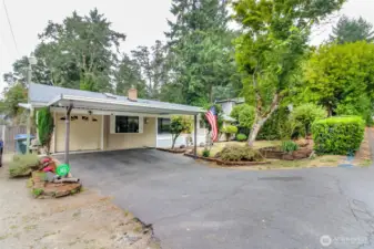 Plenty of parking with attached garage & covered carport.