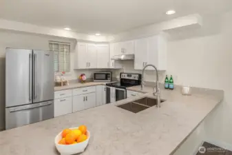 Quartz countertops with large eating bar. Window for fresh air.