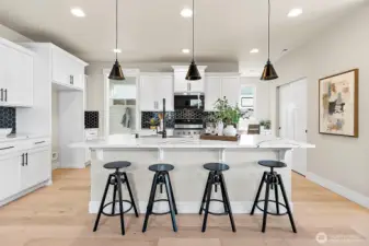 Kitchen with quartz counters and beautiful backsplash