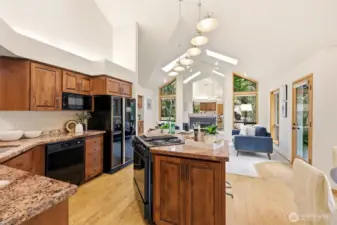 Updated eat-in kitchen features cabinets with soft-close doors, pull-out shelves, and granite countertops.