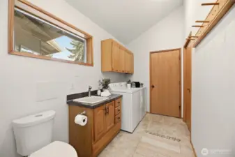 Half bathroom, laundry room and additional storage. Door leads to the garage.