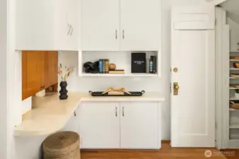 Foyer area with custom built-in storage and entrance to semi finished basement.