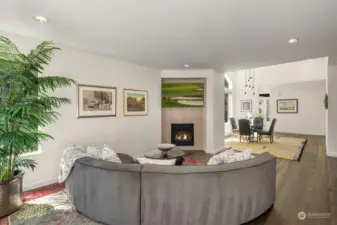 A bright and spacious living room with gas fireplace.