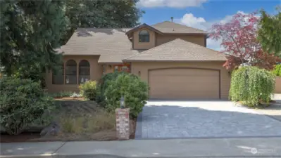 Enjoy the amazing curb appeal with the established landscaping and paver driveway.