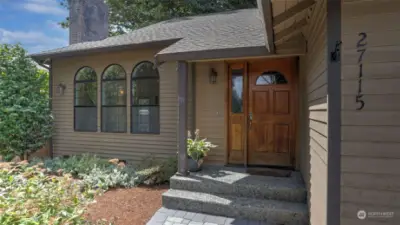 The paver sidewalk leads you to the welcoming front porch.