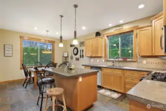 The kitchen/dining room features slate floors & a central island.