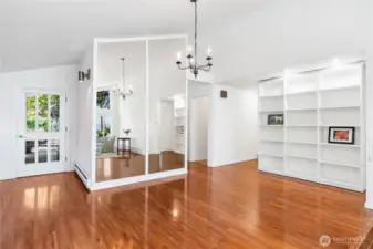The dining table can be situated under the chandelier.