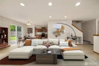 The inviting living room, featuring a cozy gas fireplace, seamlessly flows into the dining area and kitchen—creating a warm and open space perfect for gatherings and everyday living