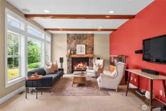 Wood burning fireplace and wall of windows next to kitchen