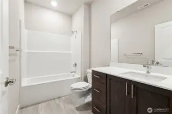 Hall bathroom. Photo rendering is representational. Actual home is under construction and finishes, elevation, and paint colors may vary. See site agent for details.