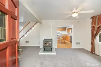 Enter into the living room, where natural light and a welcoming atmosphere greet you.