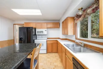 Another view of the kitchen showcasing all the cabinet storage and counter space. Don't forget the large window above the sink!