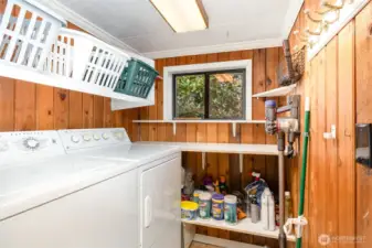 Downstairs laundry room with plenty of extra storage.