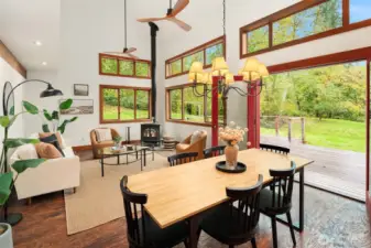 The great room is the heart of the home. French doors open to an expansive iron wood deck looking north. Inside, the vaulted ceiling and custom wood trim windows create ambiance and warmth.