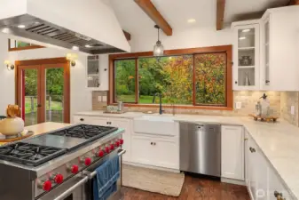 Quality meets romance in the kitchen: The classic farm sink and cottage style cabinetry seamlessly blend with the 6 burner gas range, Wolf double oven, Miele Dishwasher, and Liebherr refrigerator.
