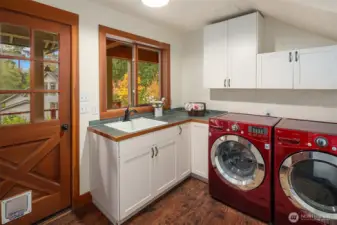 The best utility room! Private access from the deck, and a Cafe door to the kitchen makes coming and going a breeze. Abundant storage and extra sink lightens daily tasks.