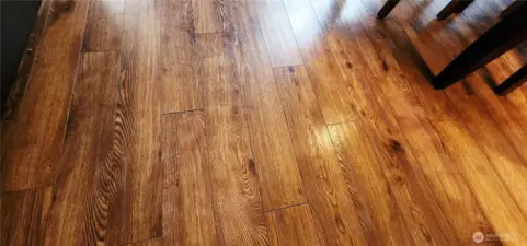 Newly installed floors are present in both the living room and dining room, signifying a recent and modern enhancement to the property.