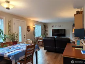 Living room and dining area with gleaming wood floors