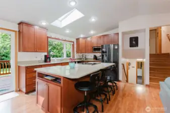 The kitchen has had a total update! New solid wood cabinets, quartz countertops, stainless steel appliances, even a motorized shade on the window! Side cabinet on the island is set up with electricity for your printer and lap top computer!