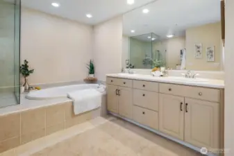The primary suite bathroom features dual sinks and a large soaking tub.