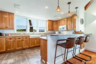 Stamped-concrete floor with radiant heat, farm sink, gas range.