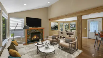 *Virtually Staged* Open living space boasts vaulted ceilings, recessed lighting, stone gas fireplace, large windows and wood beams.