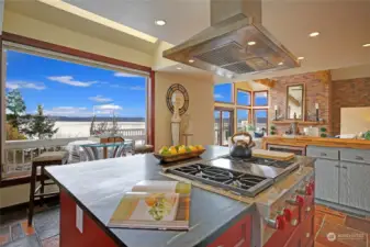 Soap stone Island with Wolf range, stainless hood, & room for a bistro table set.