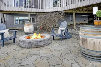 Flag stone patio with fire pit. Wind barrel tables stay as well.