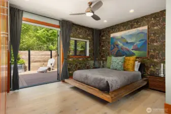 The primary suite with built-in closets opens to a private back deck.