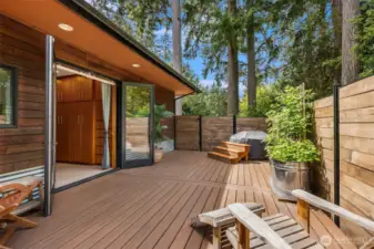 The primary suite deck includes an outdoor tub, the perfect place to soak in the stars under the night sky.