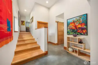 The gentle steps lead to an additional bedroom and family room. To the right is the shared bathroom and a large storage area that also houses the in-floor heating manifold.