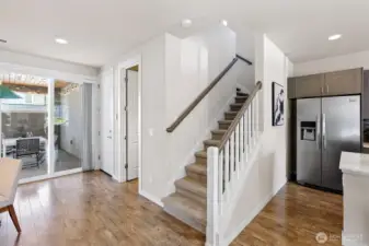 Attached garage door is tucked away from the kitchen, and downstairs features a powder room.