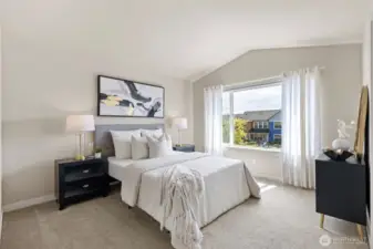 Primary bedroom features cathedral ceilings and a large walk-in closet.